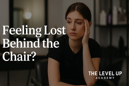 A young hairstylist sits in a salon looking tired and uncertain, resting her head on her hand. Large white text reads “Feeling Lost Behind the Chair?” and “The Level Up Academy” is displayed in the bottom right corner.